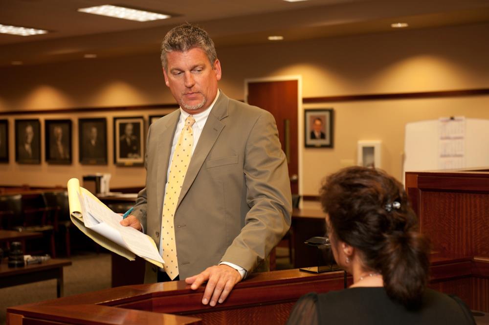 Attorney Paul J. Dickman speaking with the judge in court