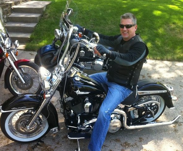 Attorney Paul J. Dickman principal from the Dickman Law Office P.S.C. riding a motorcycle