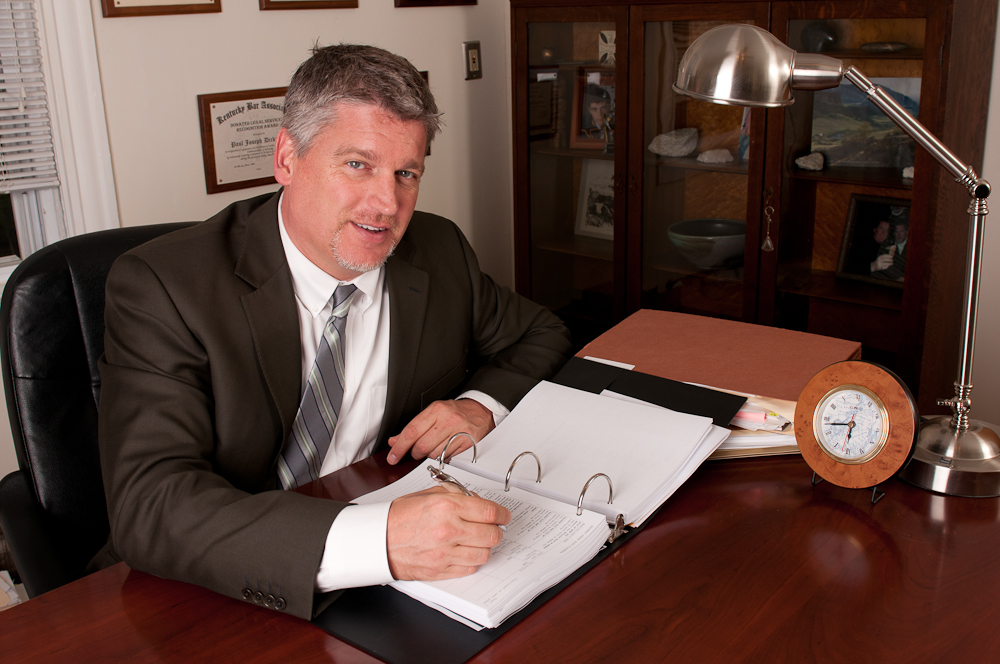 Attorney Paul J. Dickman principal from the Dickman Law Office P.S.C. sitting at his desk